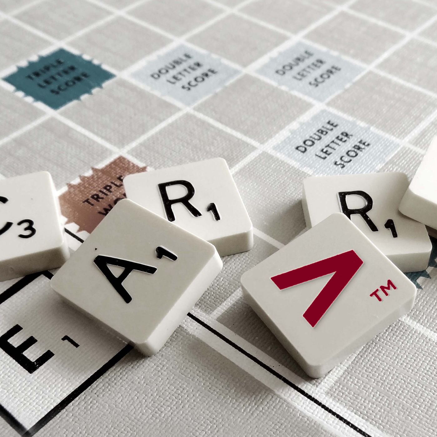 Scrabble tiles spelling Carver with the red chevron tile